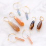 Earrings and necklaces with drop shaped natural stone beads and aura quartz crystal