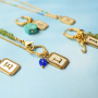 Create a unique collection with stainless steel shell charms with letters