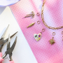 Create a funky charm necklace with metal charms with enamel